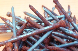 image of nails in various stages of corrosion. 