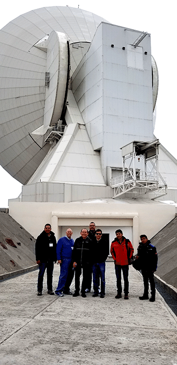 NMT and INAOE reps pose by the 50 meter telescope in Puebla