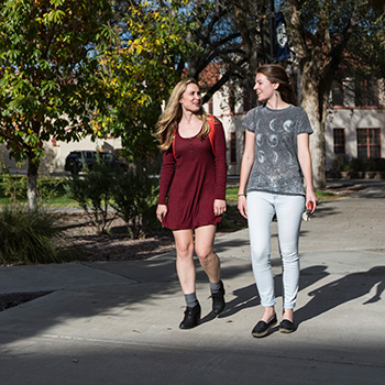 Two students walking on campus