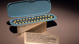 A set of oral contraceptive pills (circa 1970) and the first patient package insert from the Food and Drug Administration. 