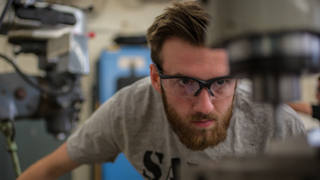 Student working at a press