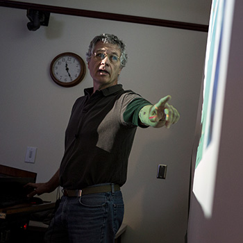 Image of a man teaching at whiteboard.