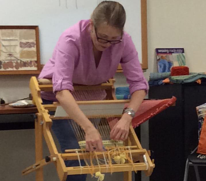teacher showing weaving experiment