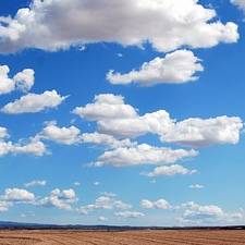 Clouds above the ground in New Mexico, spanning out towards the horizon