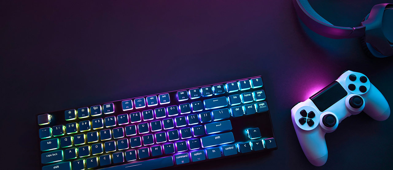 Colorful illuminated gaming accessories laying on table. Photo credit by Martin Piechotta