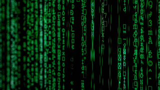 Lines of green computer code running down a monitor