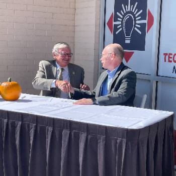 handshake NMT President Stephen G. Wells and Nusenda Credit Union CEO Joe Christian