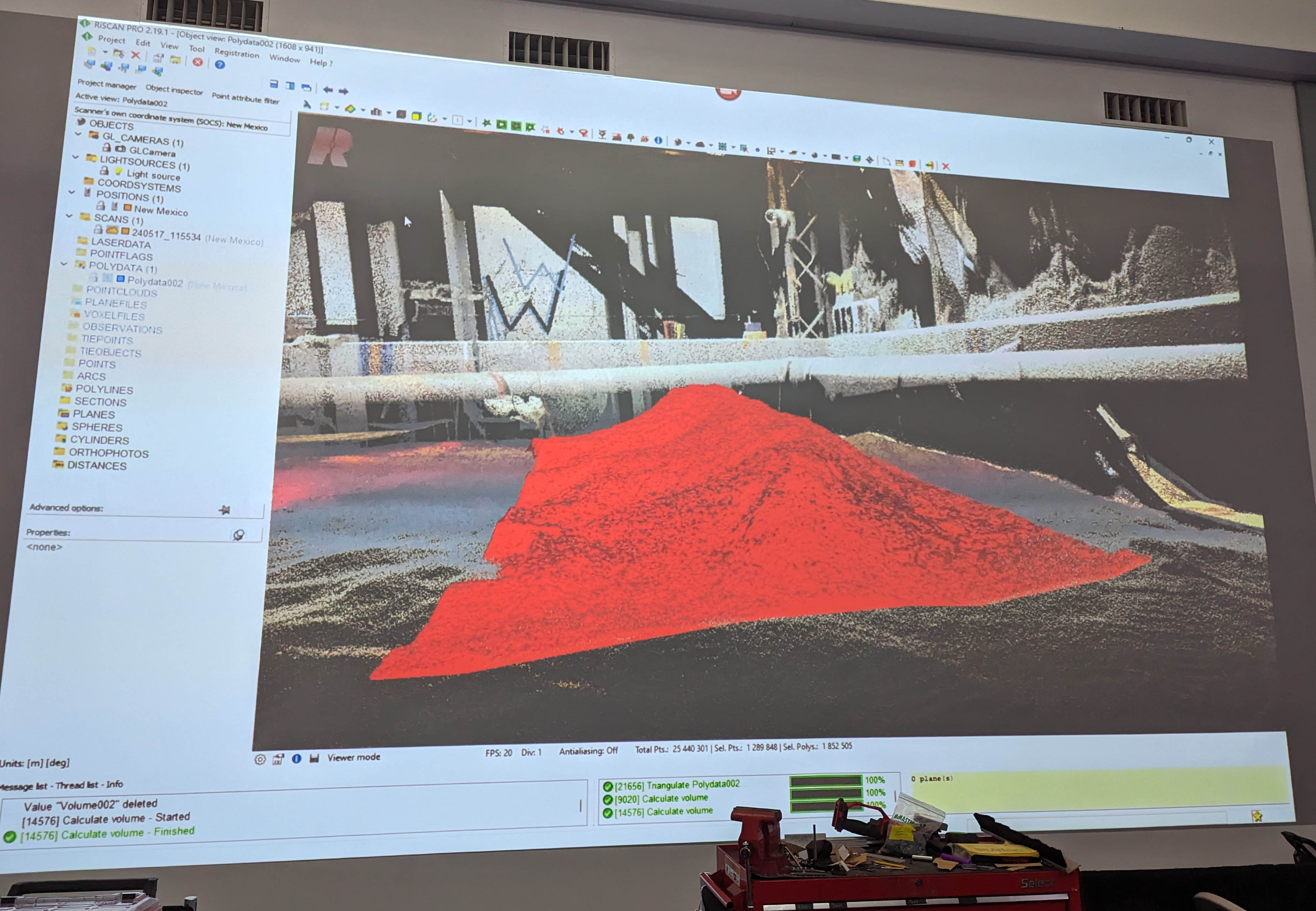 Regolith is dumped into the construction zone and carefully measured by laser to determine the total volume of material moved by the robot