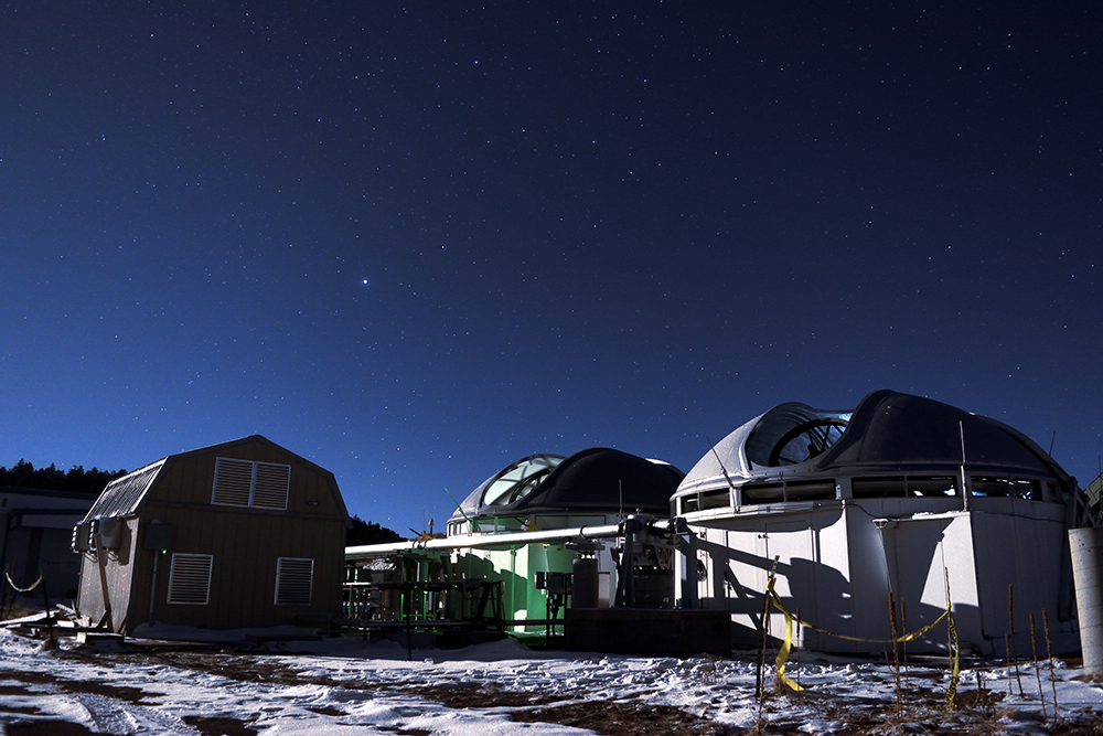 Aerial photo of MROI with telescopes superimposed to show artist's rendition of the completed astronomical facility.  The MROI will simulate a telescope up to 347 meters in diameter when it is completed.  Today MROI has 2 telescopes on the array.  (Photo Credit:  Tyson Eakman and Andres Olivares (MROI))