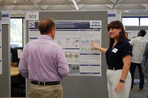 Ashley, a graduate student in Biology, explaining her project to Dr. Simpson