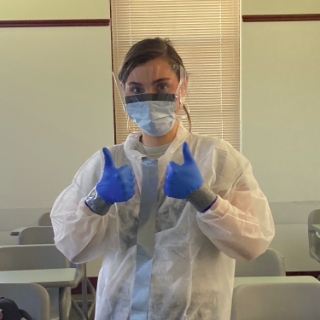 Mara dressed in lab clothes 